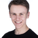 Headshot of Andrew. He has short hair, is wearing a black t-shirt, and is smiling to the camera.
